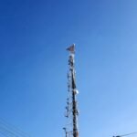 brown and white electric tower under blue sky during daytime